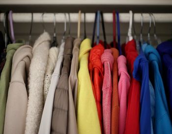 Close-up of multi colored clothes hanging on rack in store