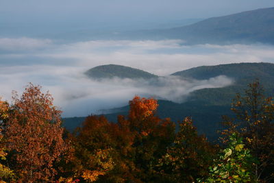 Scenic view of mountains against cloudy sky