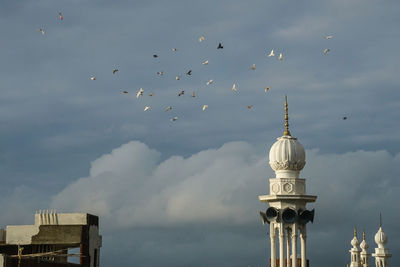 Float of birds flying through minaret