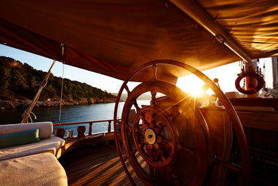 Close-up of ship on sea against sunset