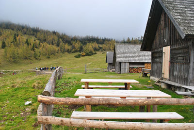 Wooden structure on grass against sky