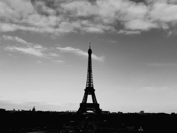 Low angle view of tower against cloudy sky