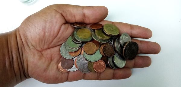 High angle view of hand holding coin