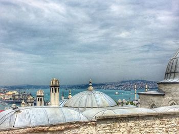 Panoramic view of sea and cityscape against sky