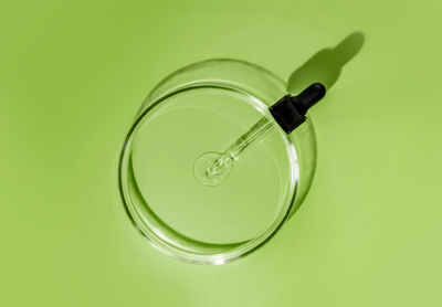 Laboratory glass petri dish with pipette and drop of water, serum, oil. medicine, cosmetic research