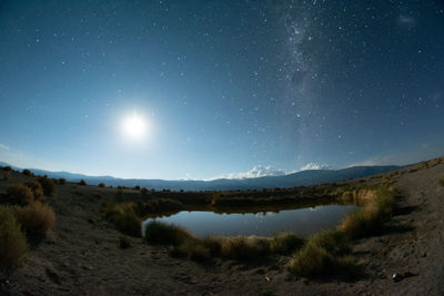 Scenic view of land against sky at night