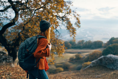Rear view of people standing outdoors