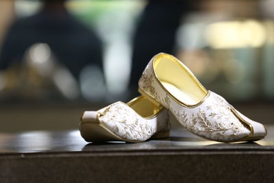 Close-up of shoes on table