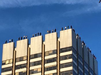 Low angle view of modern building against blue sky