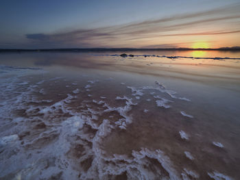 Sunset on the pink lagoon of the salt flats of torrevieja, spain