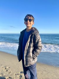 Portrait of young boy standing at beach