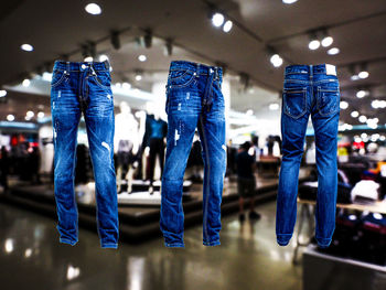 Rear view of people at illuminated store