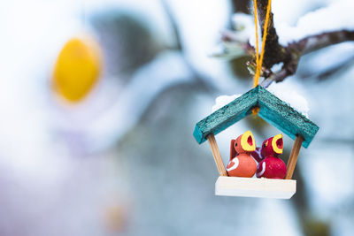 Close-up of christmas decorations hanging on snow