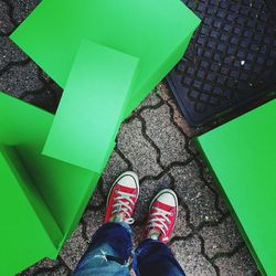 Low section of person standing by green blocks