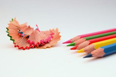 Close-up of multi colored pencils on white background