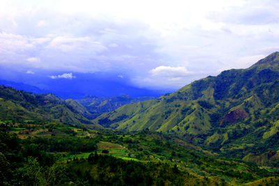 Scenic view of mountains against cloudy sky