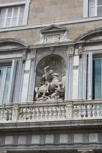 Low angle view of statue against building