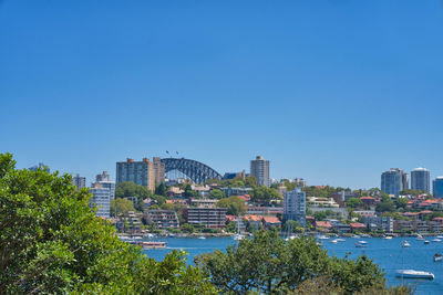 View of city buildings against blue sky