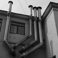 Low angle view of pipes against sky