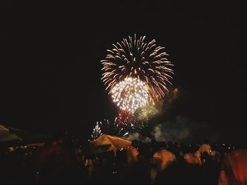 Low angle view of firework display at night