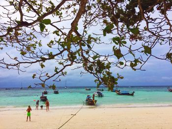 People on beach against sky