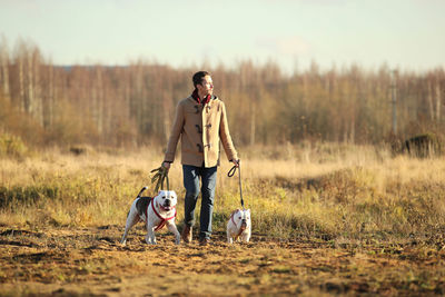 Man walking with dogs on land