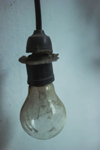 Close-up of light bulb against blue background