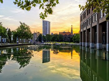 Reflection of building in lake against sky