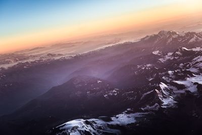 Aerial view of mountains against cloudy sky
