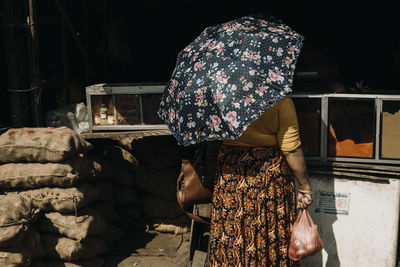 Rear view of woman standing at night