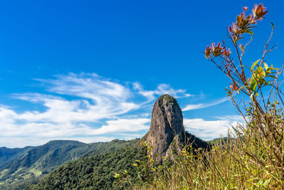 Scenic view of rocky mountains against blue sky