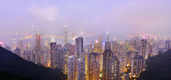 Panoramic view of illuminated cityscape against sky