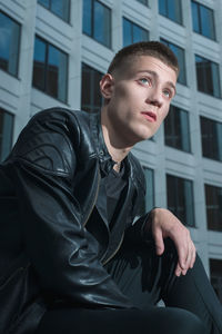 Portrait of young man sitting outdoors