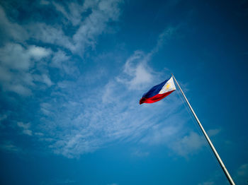 Low angle view of philippines flag against blue sky