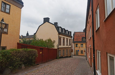 Street amidst buildings in town against sky