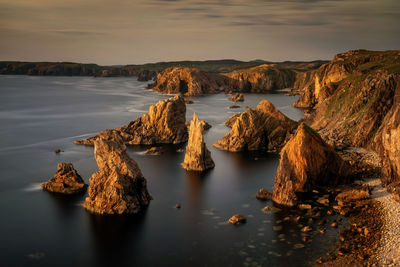 Panoramic view of rocks in sea against sky