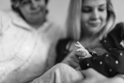 Close-up of woman holding hands at home