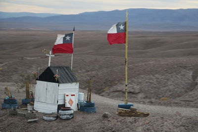 Chilean flags waving by house in desert