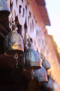 Low angle view of lantern hanging in old building