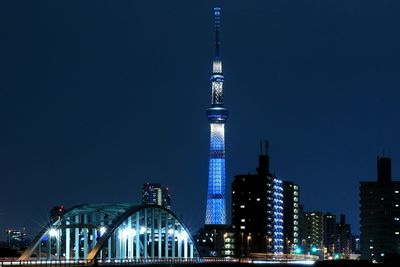 View of skyscrapers lit up at night