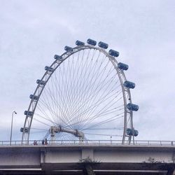 Low angle view of ferris wheel against sky