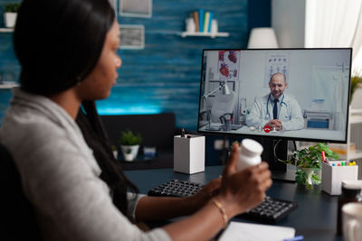 Woman consulting with doctor on video conference