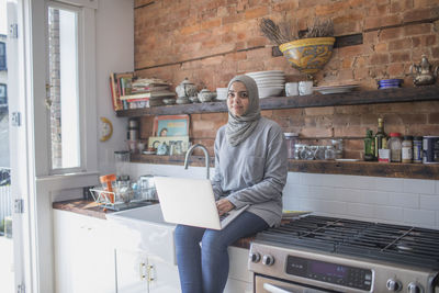 Muslim businesswoman working from home on her laptop