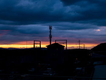 Silhouette buildings against sky at sunset