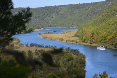 High angle view of calm river along trees