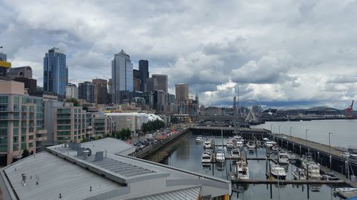 Cityscape against cloudy sky