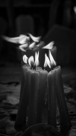 Close-up of illuminated candles on table