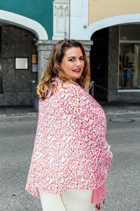 Portrait of smiling woman in city