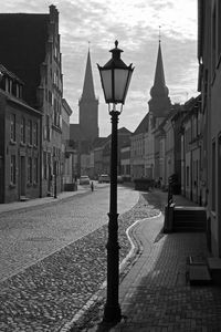 Street light amidst buildings in city