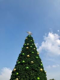 Low angle view of christmas tree against sky